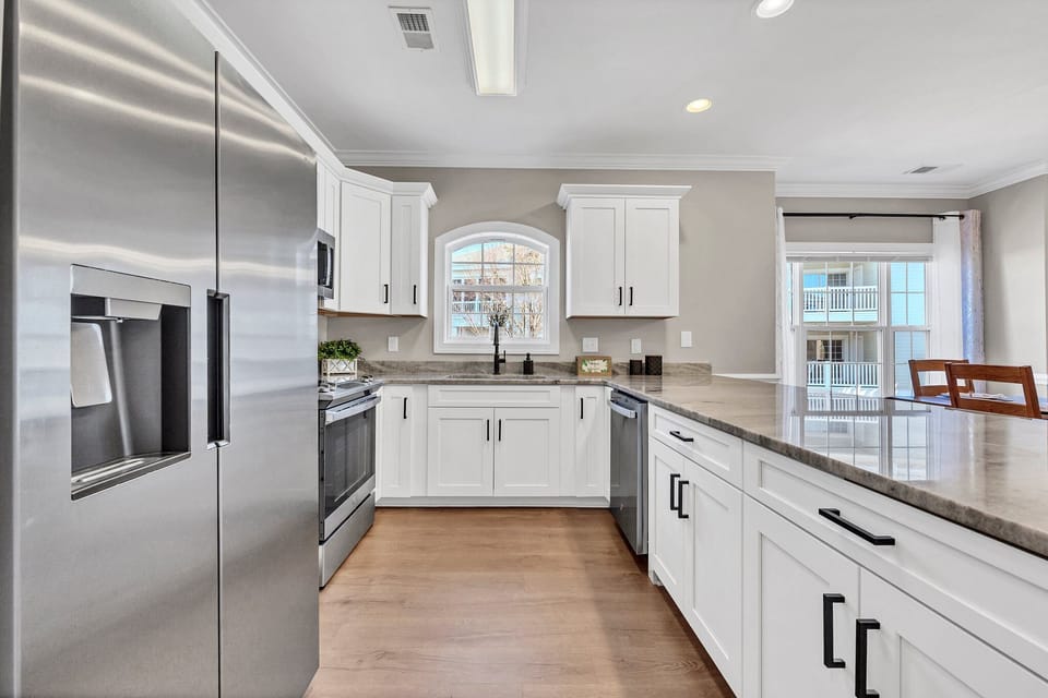 Modern kitchen with upgraded stainless steel appliances and granite countertops.