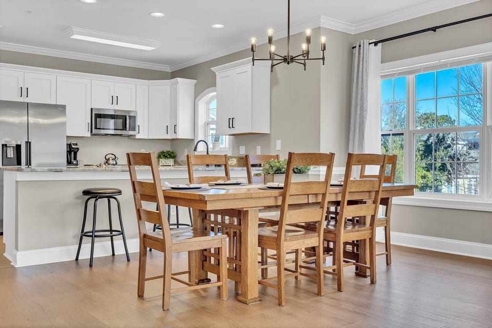 There is seating for 6 at the dining table and 3 additional barstools.