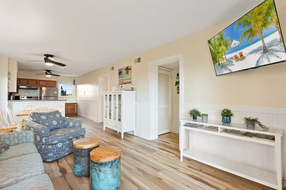 The Living Area features a flat-screen TV and access to the deck, perfect for enjoying those cool breezes right off the ocean.