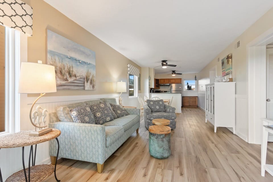 The Living Area features a flat-screen TV and access to the deck, perfect for enjoying those cool breezes right off the ocean.