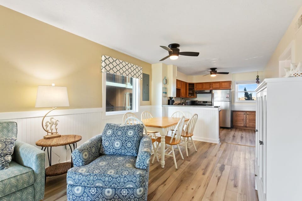 The Living Area features a flat-screen TV and access to the deck, perfect for enjoying those cool breezes right off the ocean.