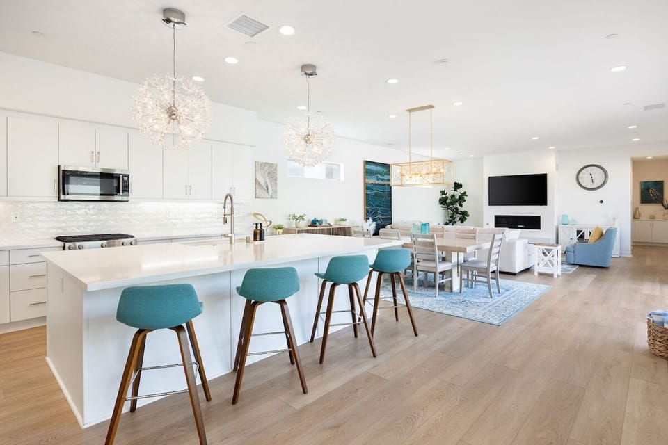 Open kitchen with island seating flows into the dining and living areas.