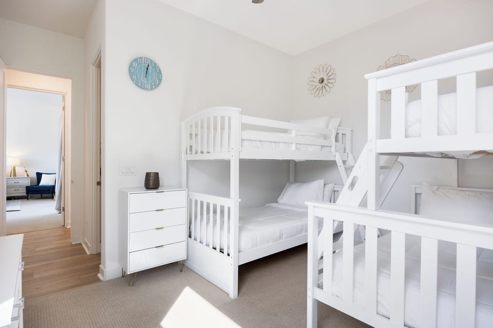 White bunk beds and coastal decor.