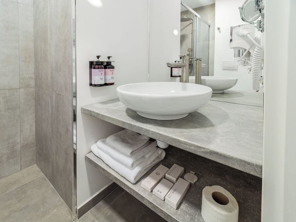 Shower, hair dryer, slippers, towels