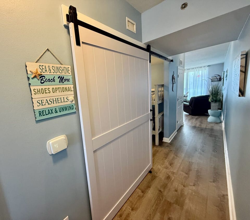 Cozy bunk bedroom with stylish barn doors for added privacy and charm.