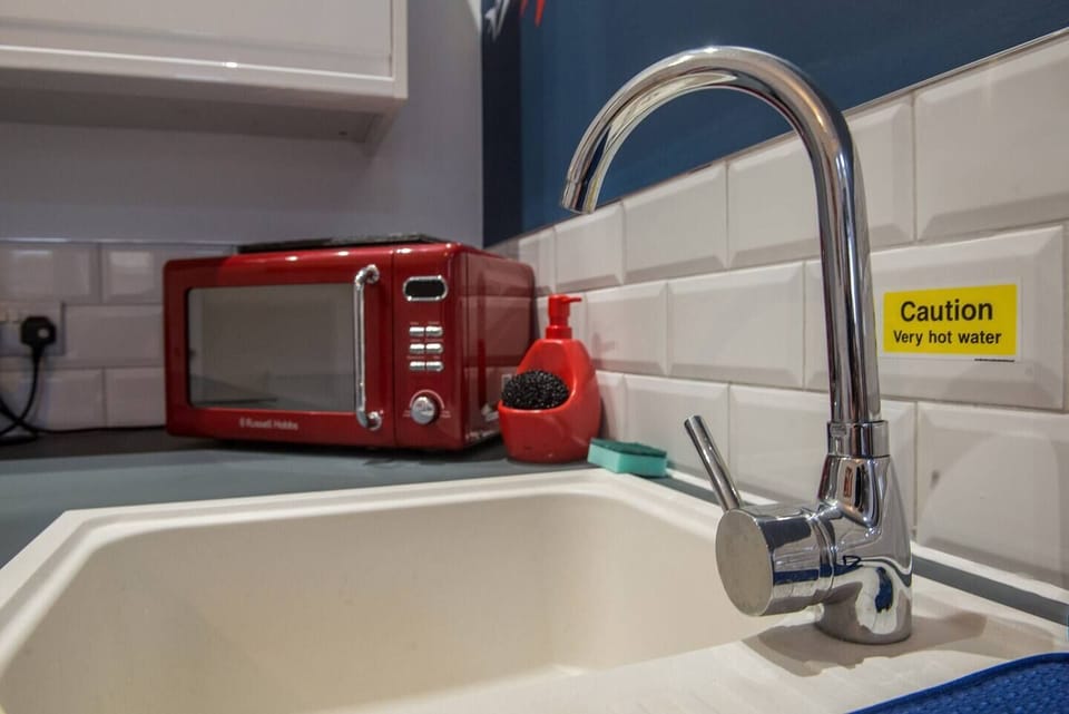 Includes, microwave, oven and hob, fridge with small freezer, kettle and washing machine