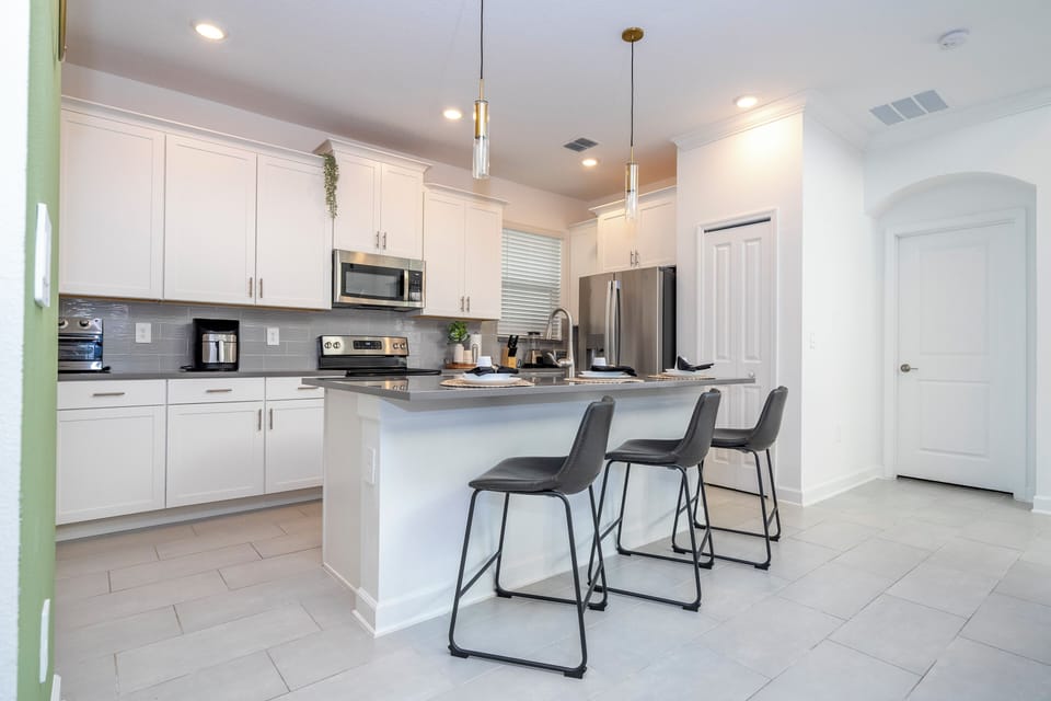 The open-concept kitchen features a spacious island, stainless steel appliances, and a modern design, perfect for cooking and entertaining.