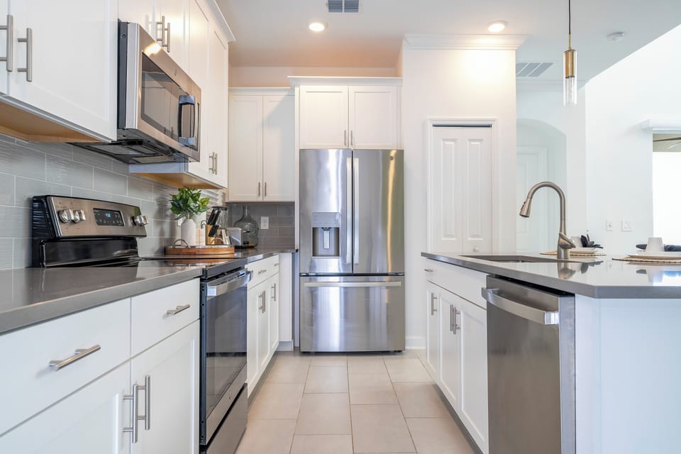 The fully equipped kitchen features modern appliances, sleek cabinetry, and all essential cookware and utensils, making it perfect for preparing meals with ease.