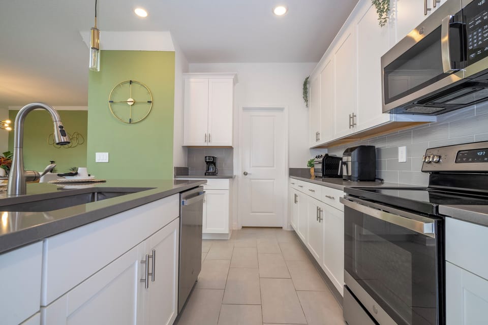 The fully equipped kitchen features modern appliances, sleek cabinetry, and all essential cookware and utensils, making it perfect for preparing meals with ease.