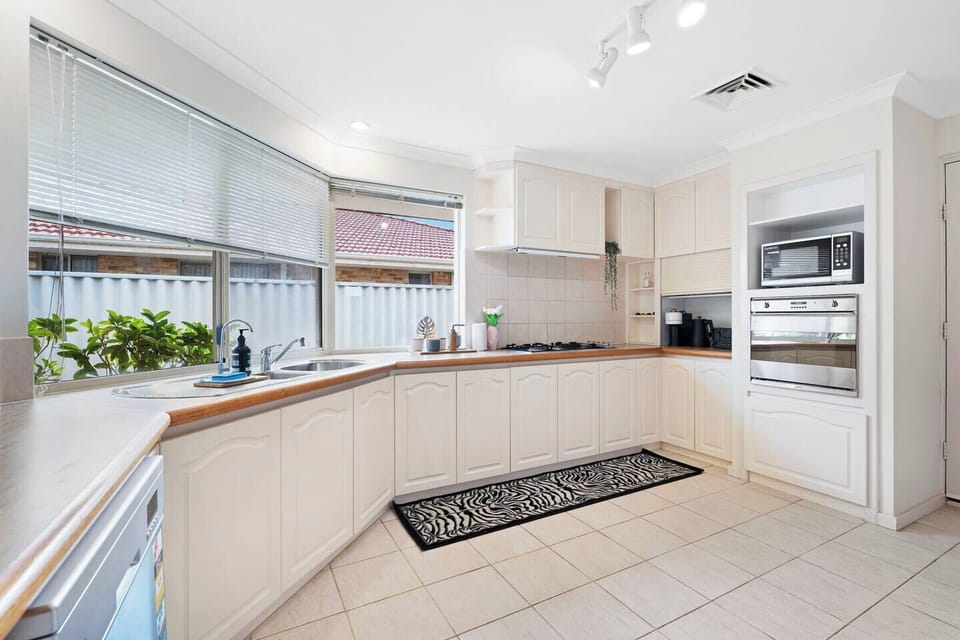 Fully equipped kitchen with generous counter space and classic cabinetry.