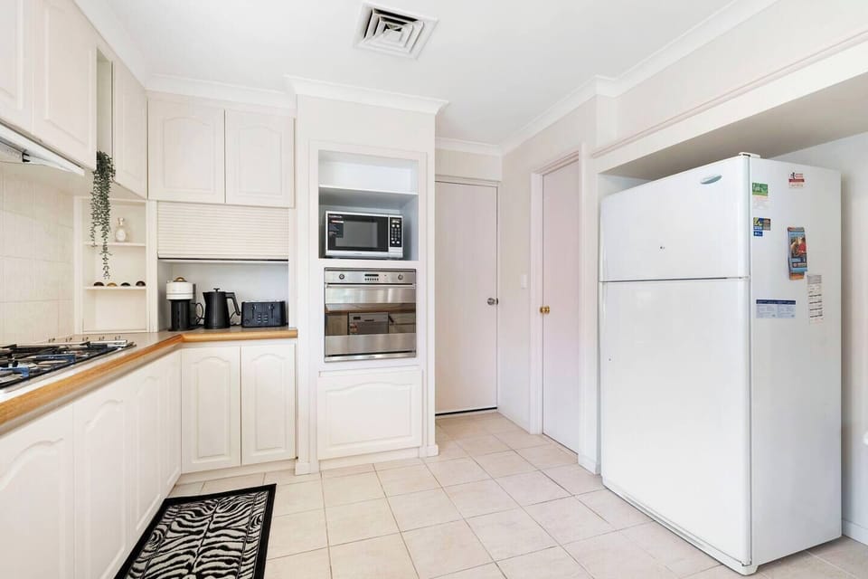 Convenient kitchen nook with appliances and extra storage.