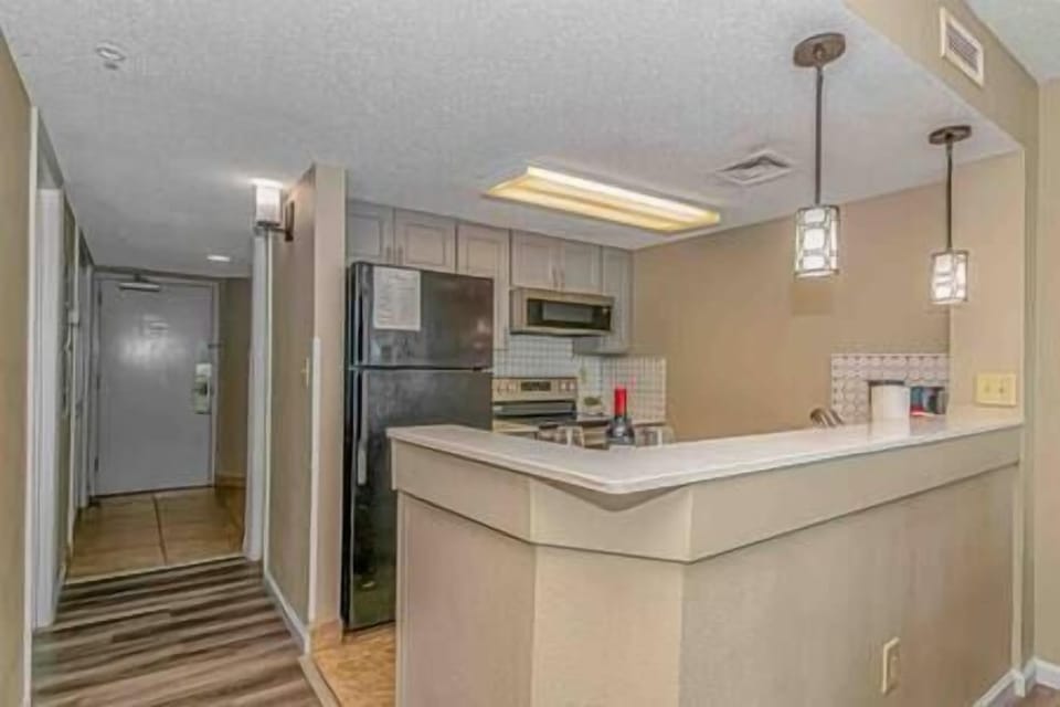 Updated kitchen view with hallway and entry view. Master en-suite is right off of the kitchen.