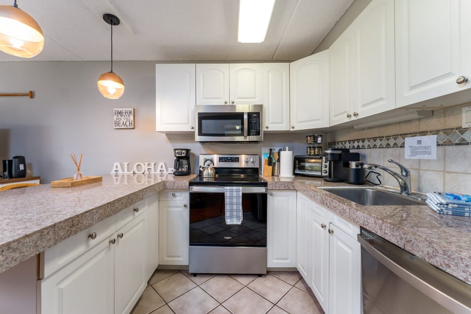 Modern kitchen with stove/oven, mocrowave, dishwasher, fridge, coffee maker, toaster and many more