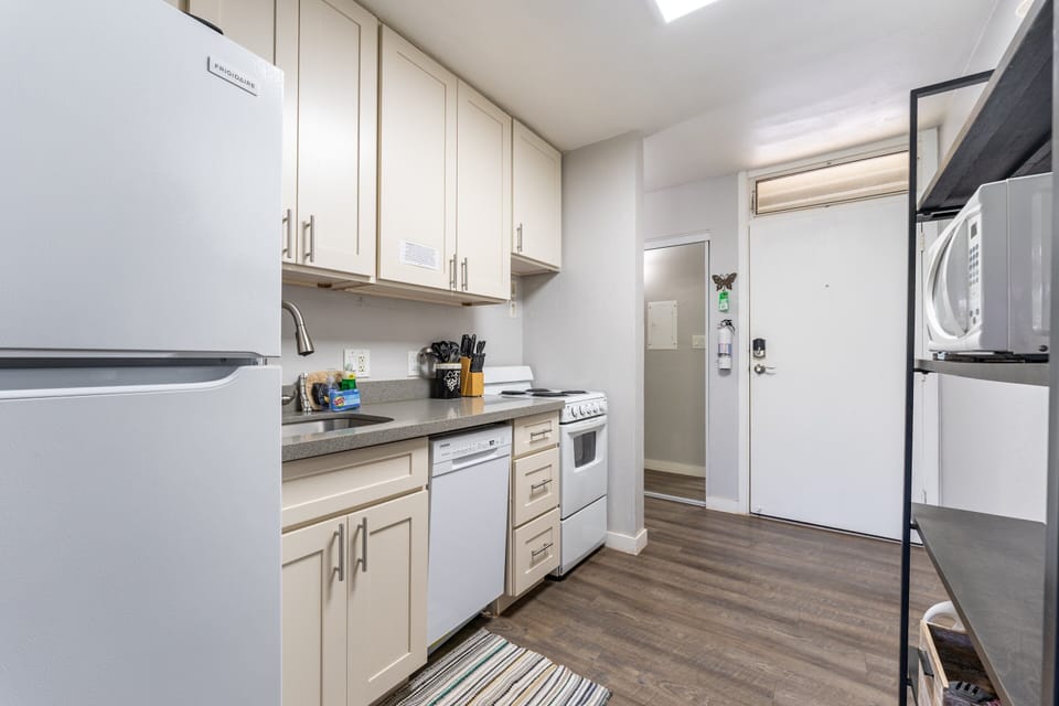 Kitchen has stove, oven, fridge, dishwasher, coffee maker, microwave