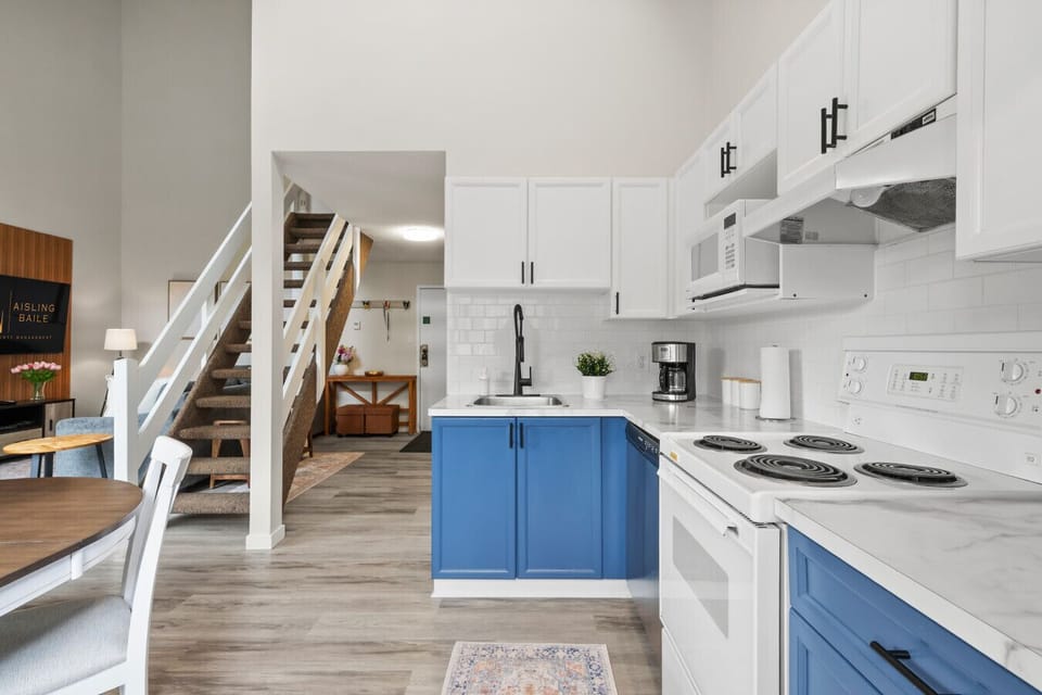 Full kitchen with a 4-person dining set & mountain views.