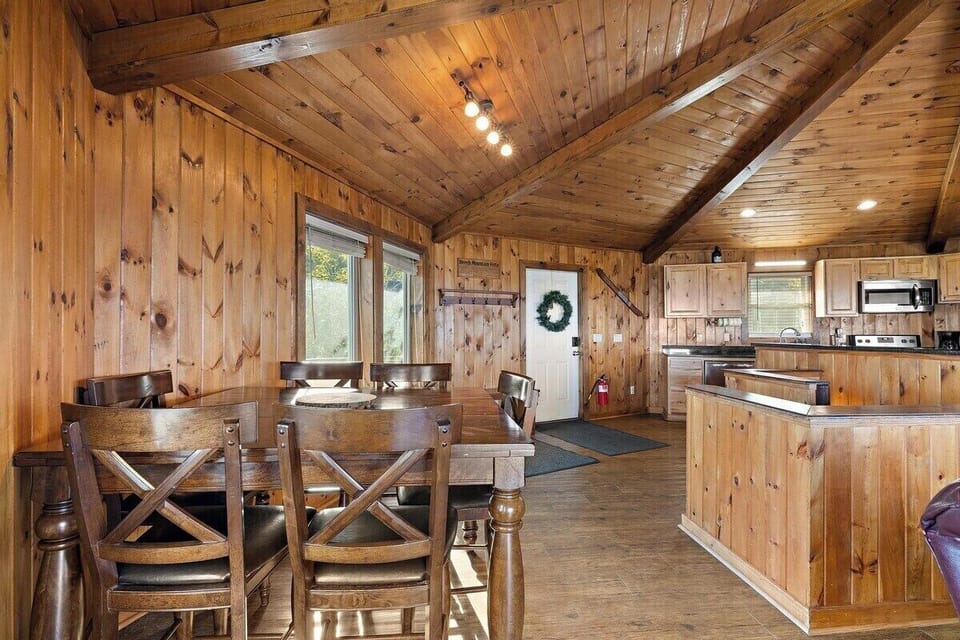 Enjoy meals together in this warm, wood-accented space with plenty of natural light and open flow to the kitchen.