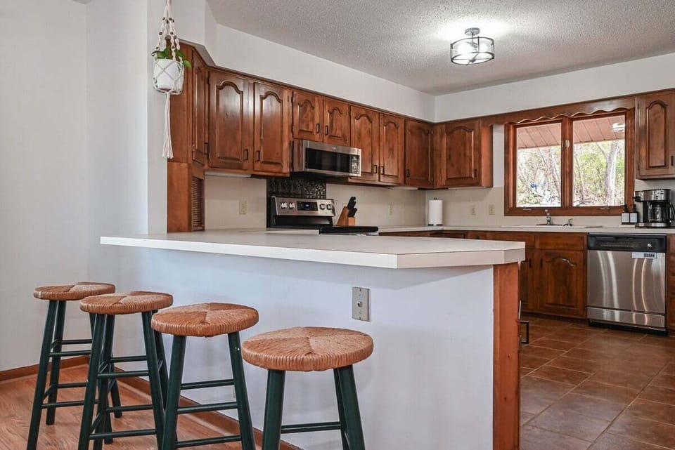 Updated kitchen with island seating and views into the living room.