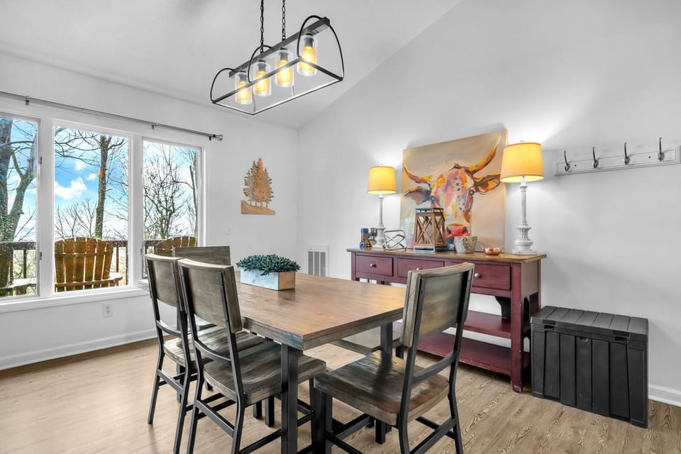 Bright dining area with seating for your group, natural light, and easy access to the open kitchen and living room.