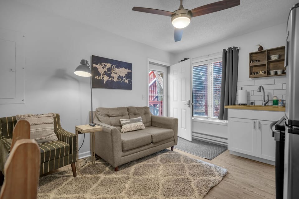 A mother-in-law living suite with a sofa, smart TV, and cozy layout — perfect for movie nights or extra privacy.