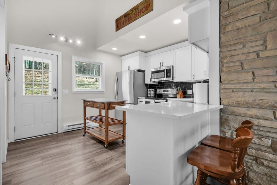 Clean, modern kitchen right off the main entry. Fully equipped with cookware, stainless appliances, and plenty of prep space.