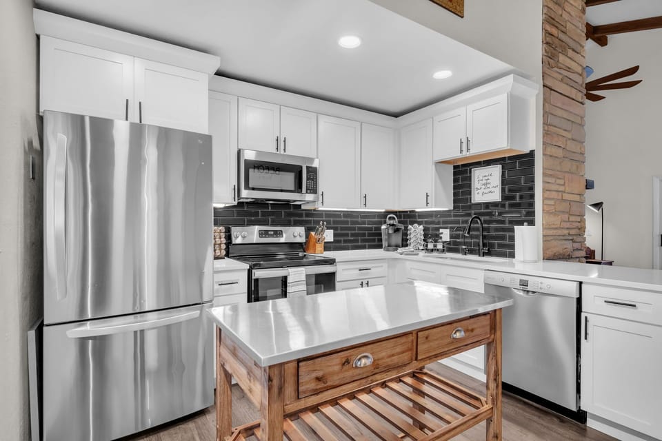 Updated refrigerator, stove, dishwasher, and microwave for a comfortable, home-style stay.