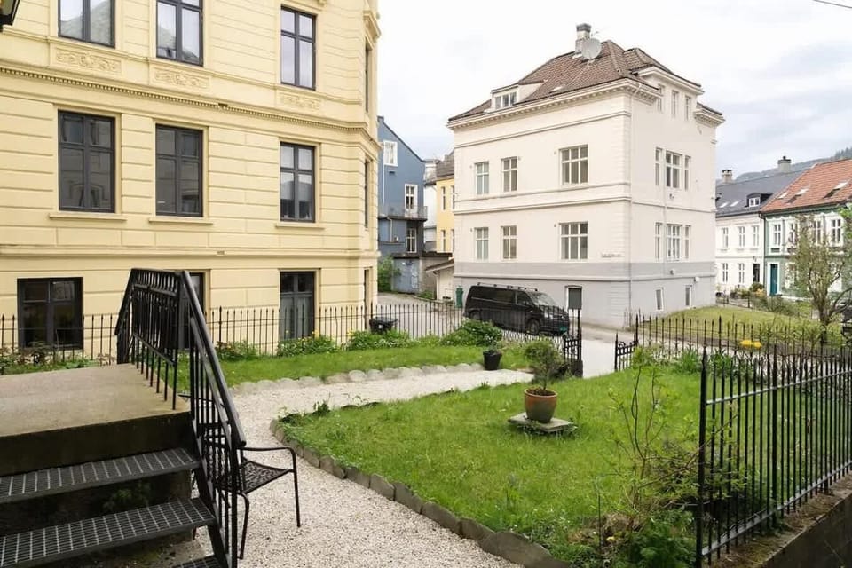 Stone steps, iron railings, and greenery set a charming first impression.