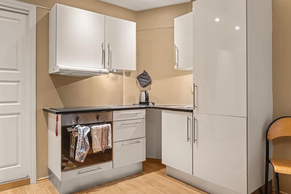 Clean and modern with white cabinetry and full appliances—ideal for cooking in.
