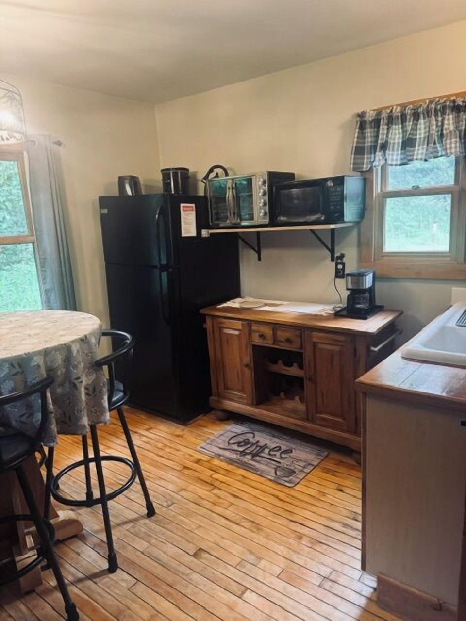 Kitchen and dining area. Nicely equipped kitchen: Large air fryer, refrigerator, microwave, coffee maker, toaster, dishes, utensils and cooking basics