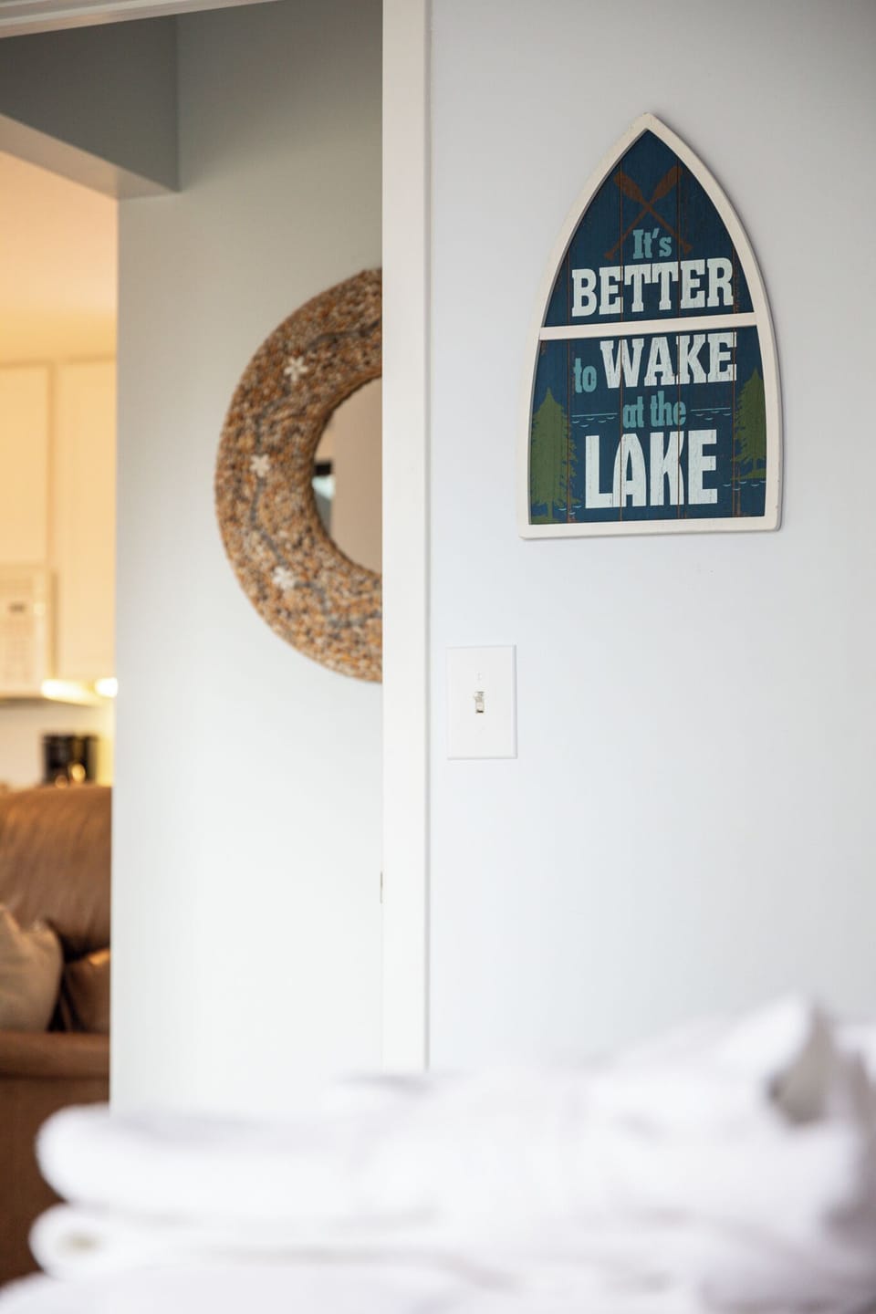 Lake-inspired wall decor adds a charming, coastal touch to the space.