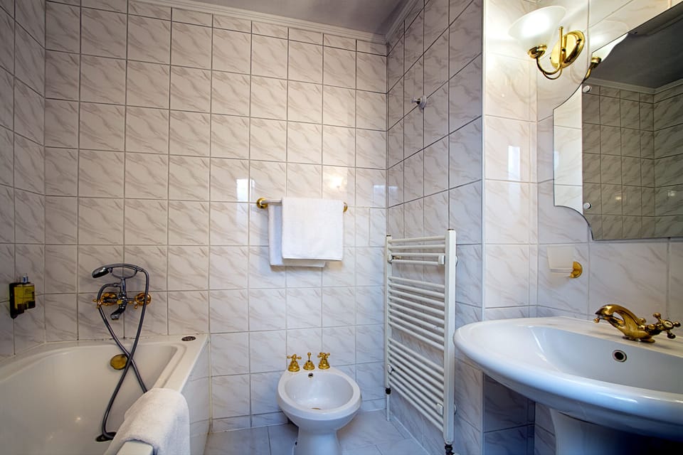 Deep soaking tub, designer toiletries, hair dryer, towels
