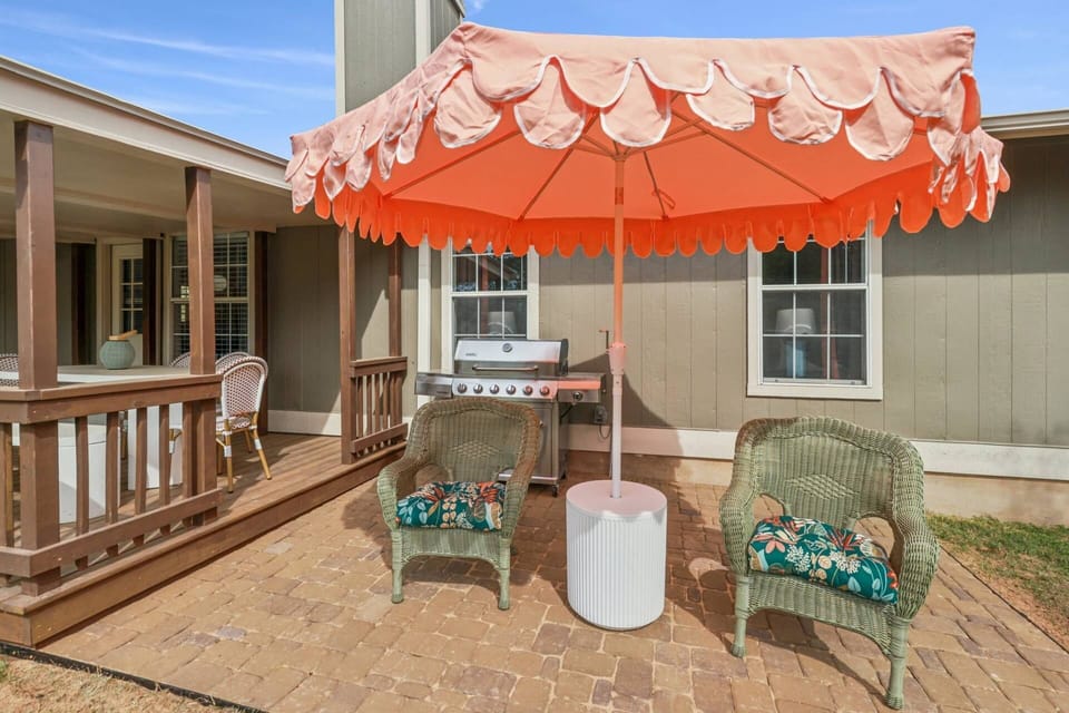 Outdoor seating with umbrella and propane BBQ grill