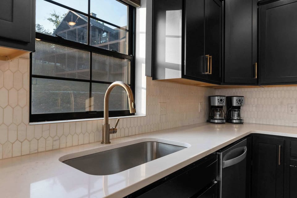 Gorgeous, modern kitchen design with a large sink and polished finishes 