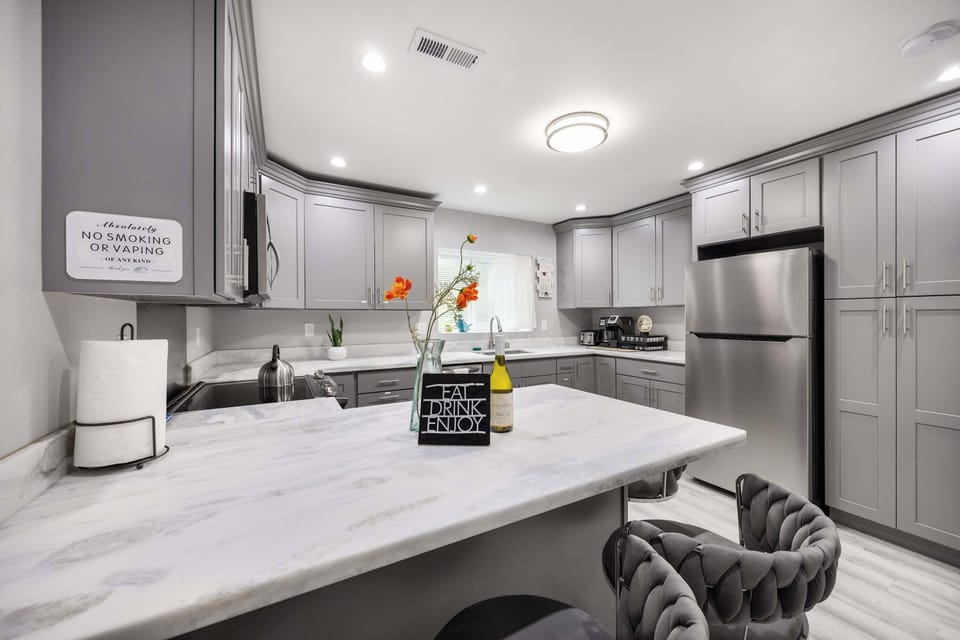 The breakfast bar adds a cozy touch, perfect for casual dining or enjoying a morning coffee.