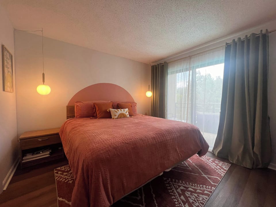 Relax in the king suite, boasting an ensuite bath, smart TV, & balcony