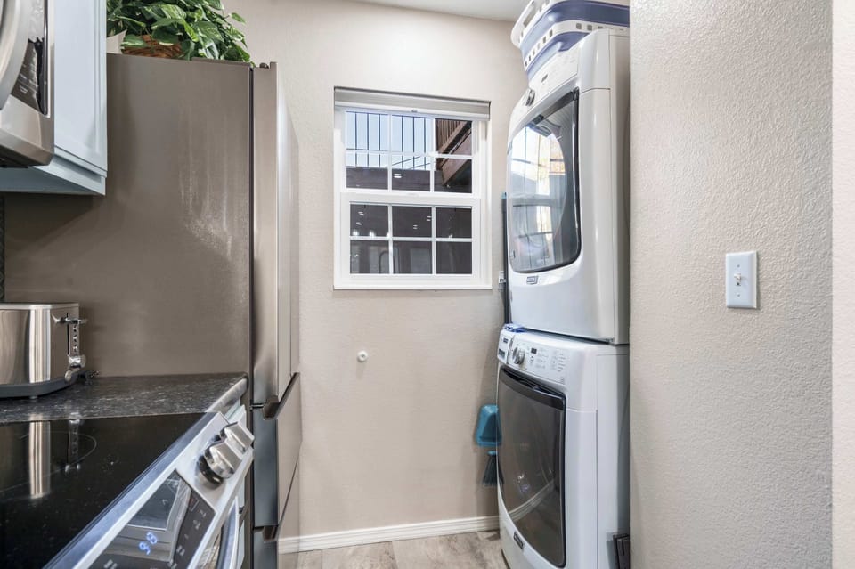 Private laundry is available for your stay, tucked away in the kitchen
