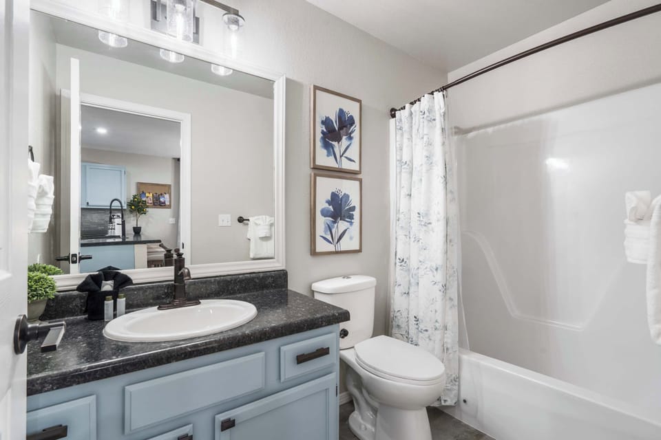 Wash up in the first full bath, showcasing a single vanity & shower/tub combo