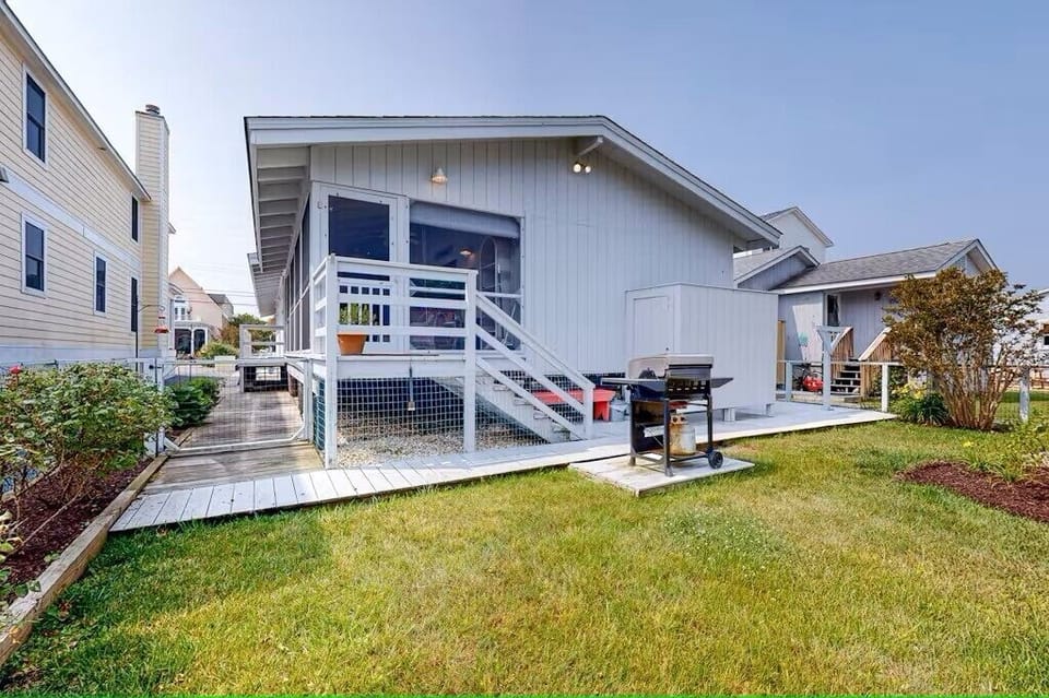 Backyard with grill,  beach chairs  and outdoor shower