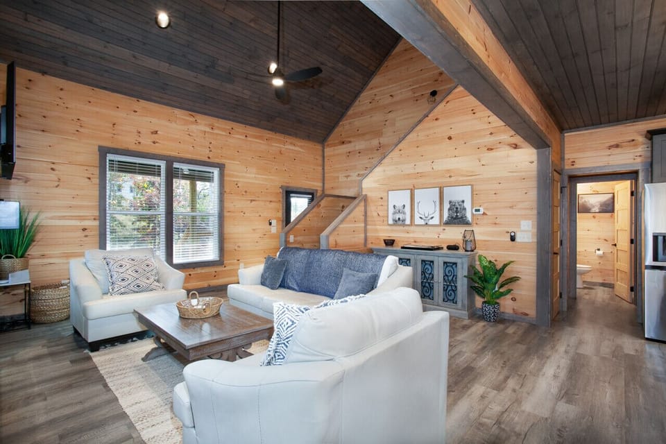 Open living space with fireplace, vaulted ceilings, and rustic-modern accents.