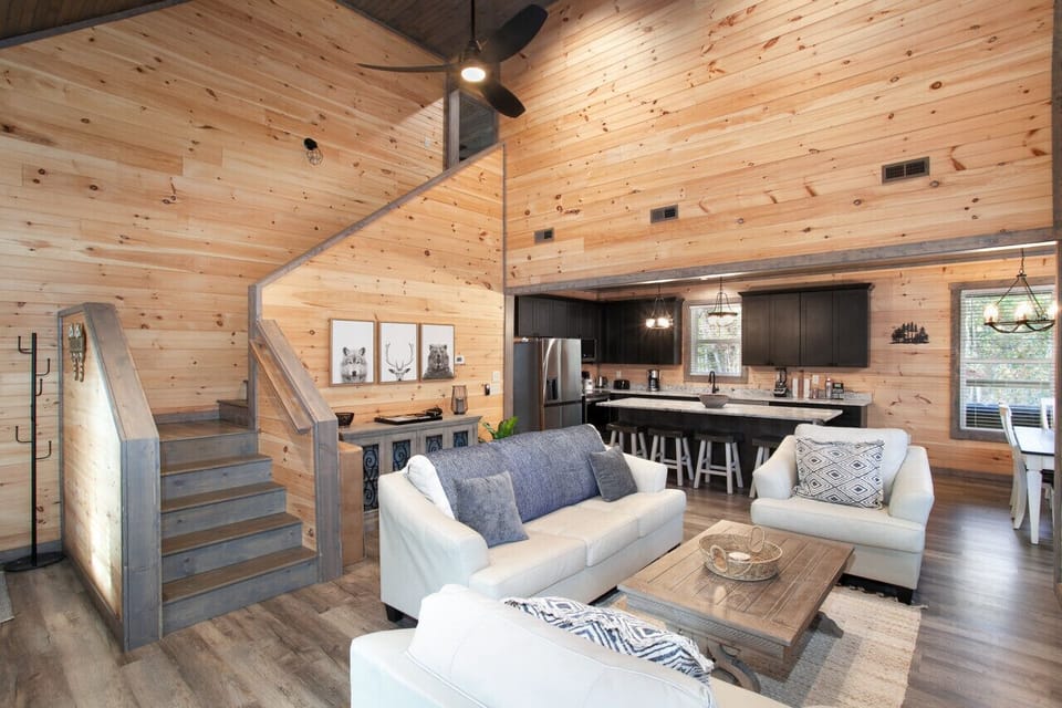 Spacious rustic living area with vaulted ceilings and modern kitchen accents.