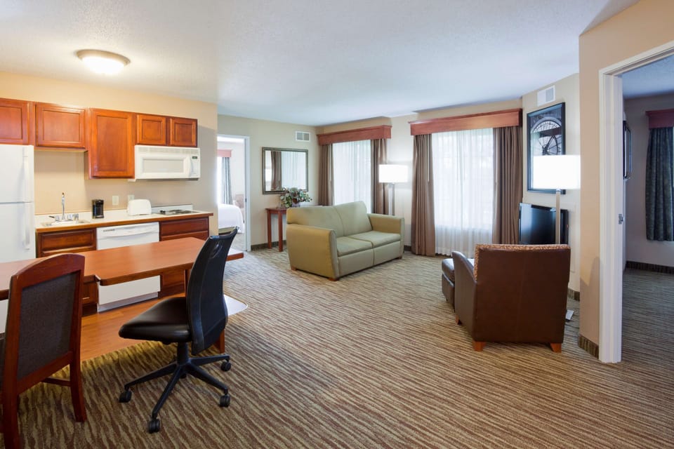 Premium bedding, desk, laptop workspace, blackout drapes