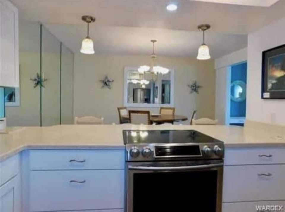 Glass topped stove and kitchen bar looking into Din Rm. 4 stools