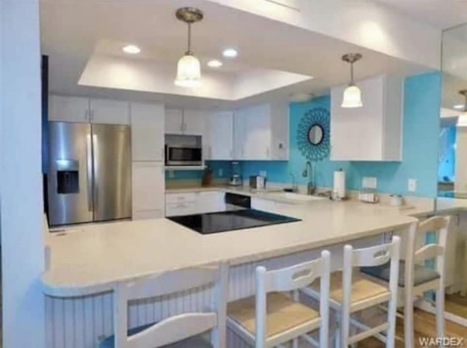 Kitchen counter bar and stools.  Lots of light!