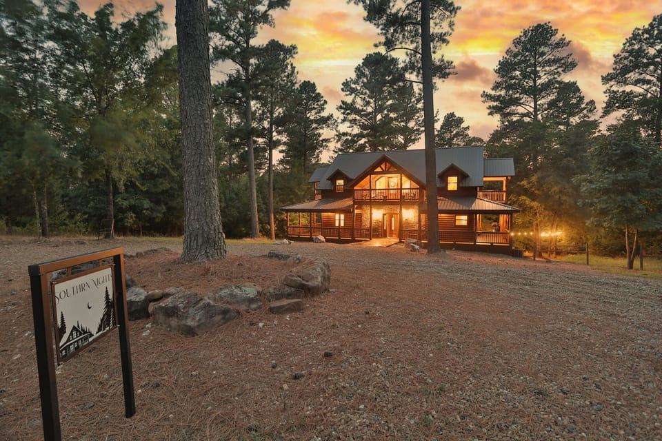 A cozy, glowing retreat nestled among towering pines, perfect for serene getaways.