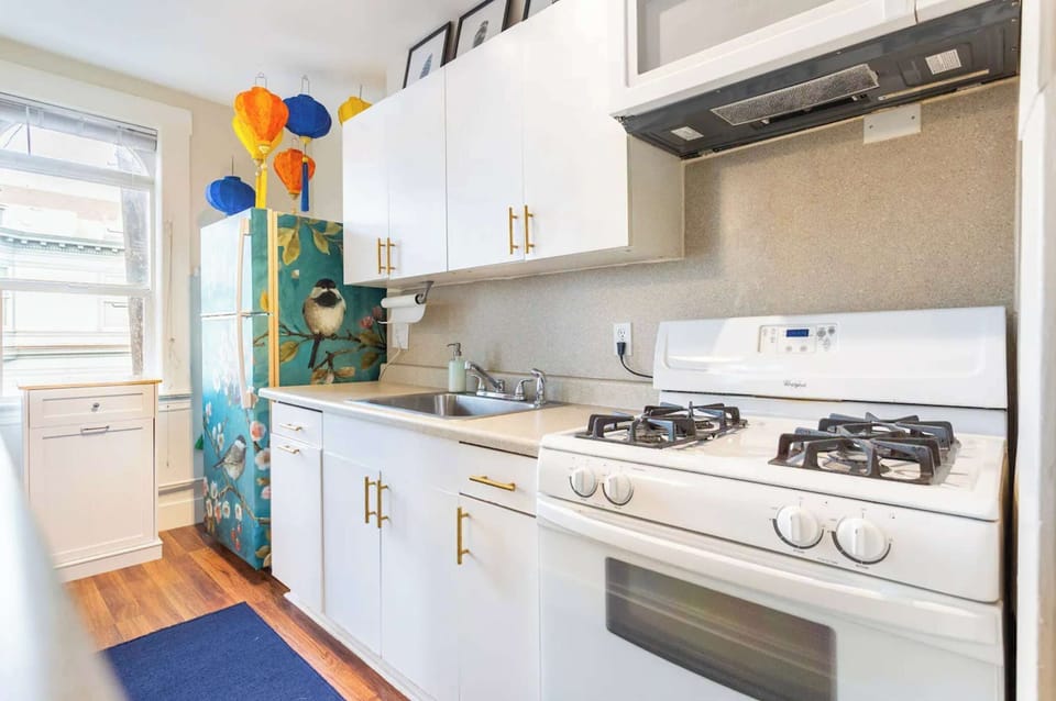 Step into a fully equipped kitchen where culinary creativity meets artistic flair. From fun decorations to a customized painted fridge, this space is as unique as it is functional.