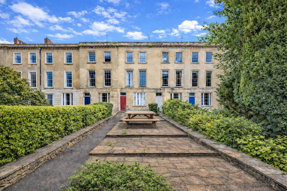 The elegant Georgian façade of our 1841 Clifton townhouse, tucked away in a quiet green setting just steps from the cafés, restaurants, and cinema of Whiteladies Road.