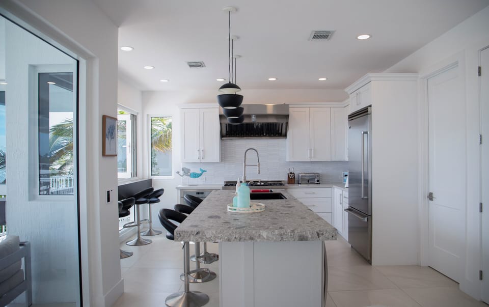 Kitchen has gas range and double oven, dishwasher, wine cooler and fridge