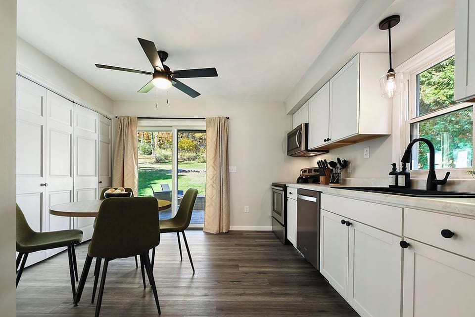 Bright, modern kitchen with a cozy dining area and views of the backyard. Step outside for fresh air and to relax on the patio—perfect for morning coffee, family meals, or a quick bite before exploring nearby attractions!
