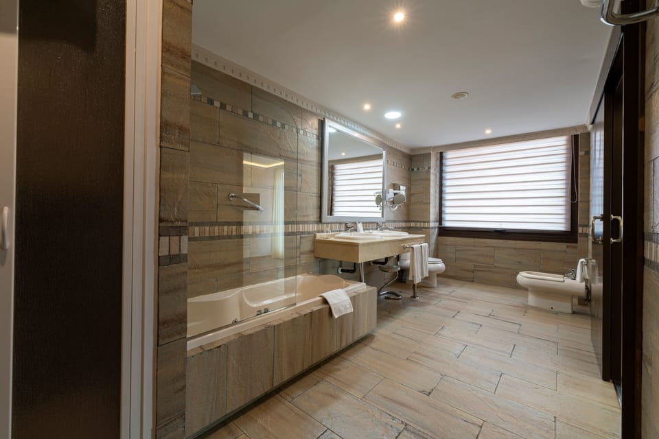Superior Suite, Hot Tub | Bathroom | Hair dryer, bidet, towels