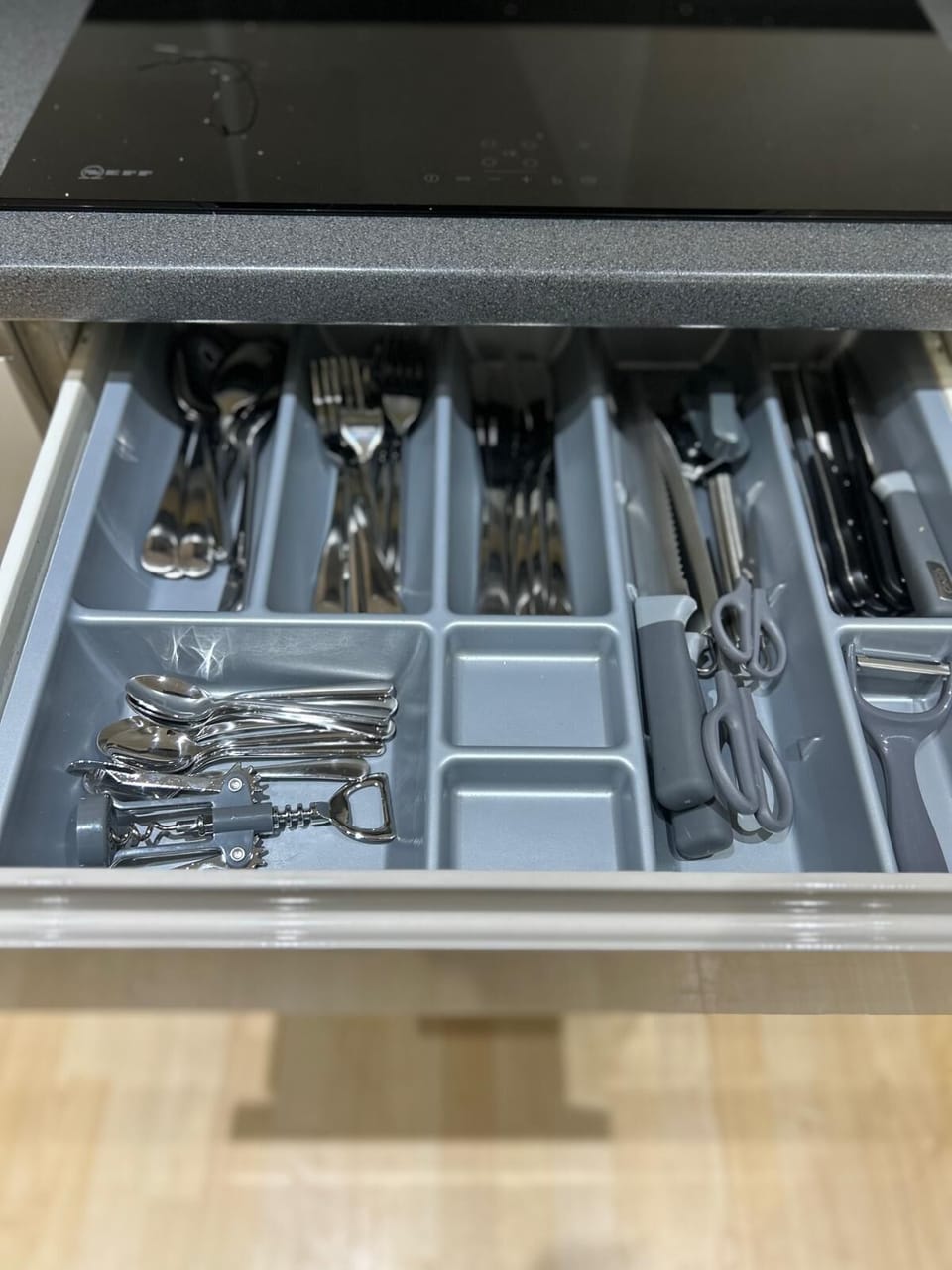 Well-stocked cabinet with utensils, perfect for all your dining and cooking needs during your stay