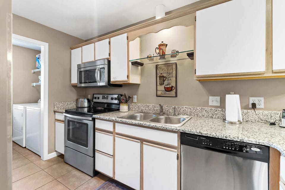 The airy kitchen offers ample space & every home comfort